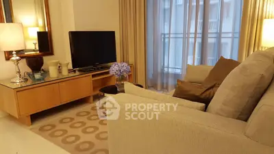 Cozy living room with modern decor, large sofa, and flat-screen TV, perfect for relaxation.