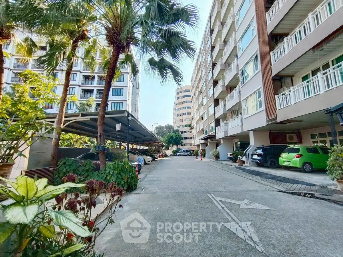 Charming residential building with lush greenery and ample parking space