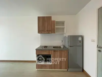 Modern compact kitchen with sleek appliances and wooden cabinetry