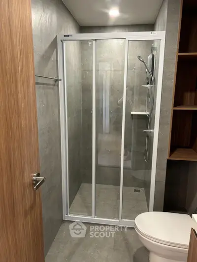 Modern bathroom with sleek shower enclosure and contemporary fixtures.