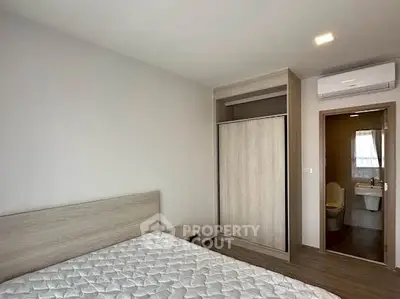 Modern bedroom with ensuite bathroom and built-in wardrobe in a stylish apartment.