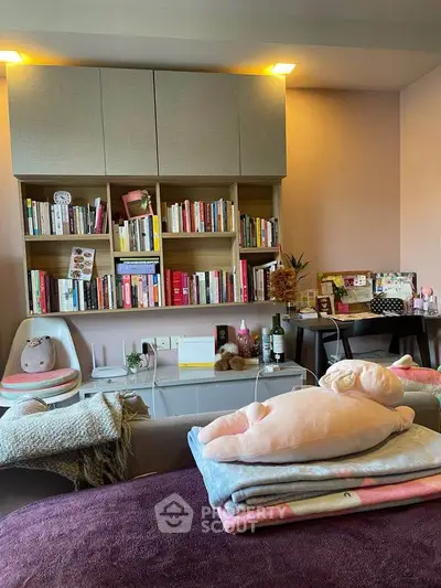 Cozy study room with bookshelves and plush decor, perfect for relaxation and productivity.