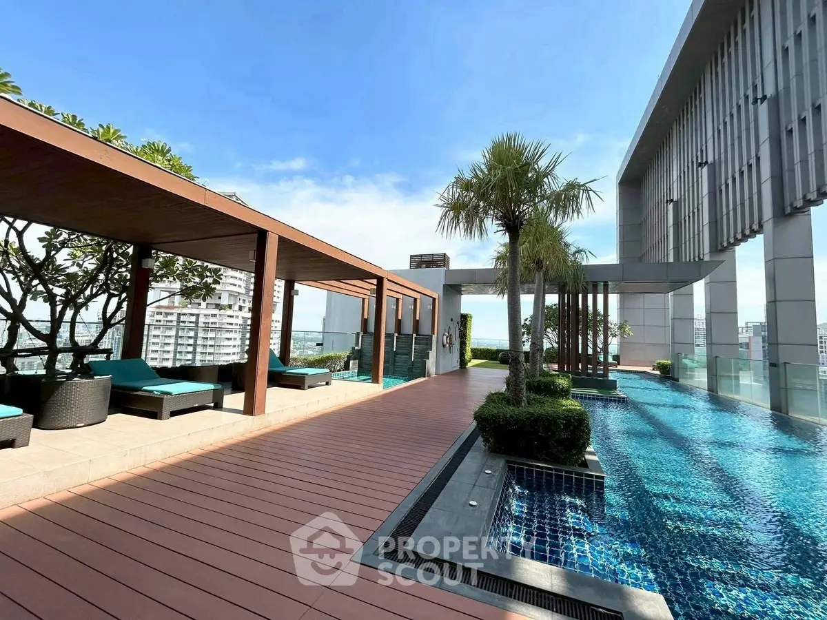 Luxurious rooftop pool with stunning city views and modern lounge area.