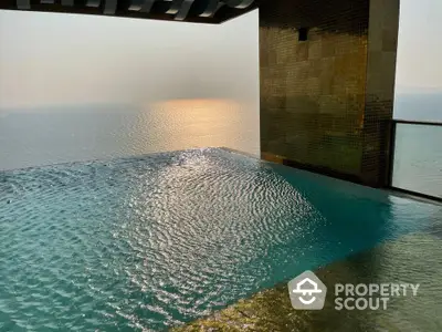 Luxurious infinity pool with breathtaking ocean view at sunset