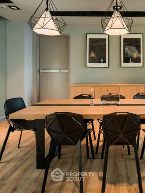 Modern dining area with stylish lighting and wooden flooring