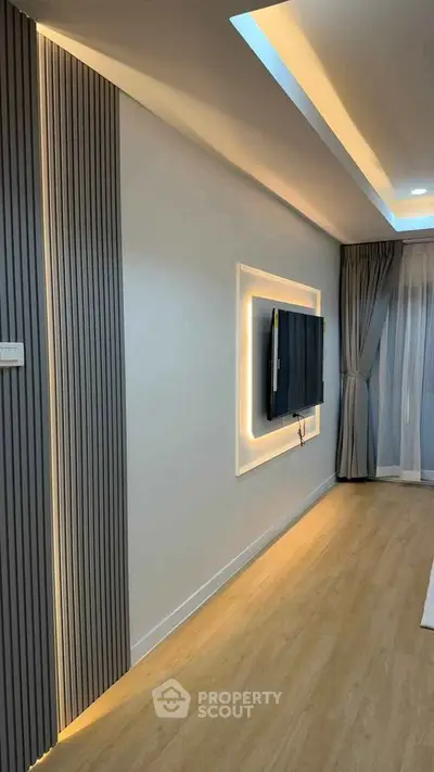 Modern living room with sleek TV setup and ambient lighting