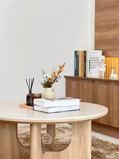 Stylish modern living room with wooden coffee table and decorative books.