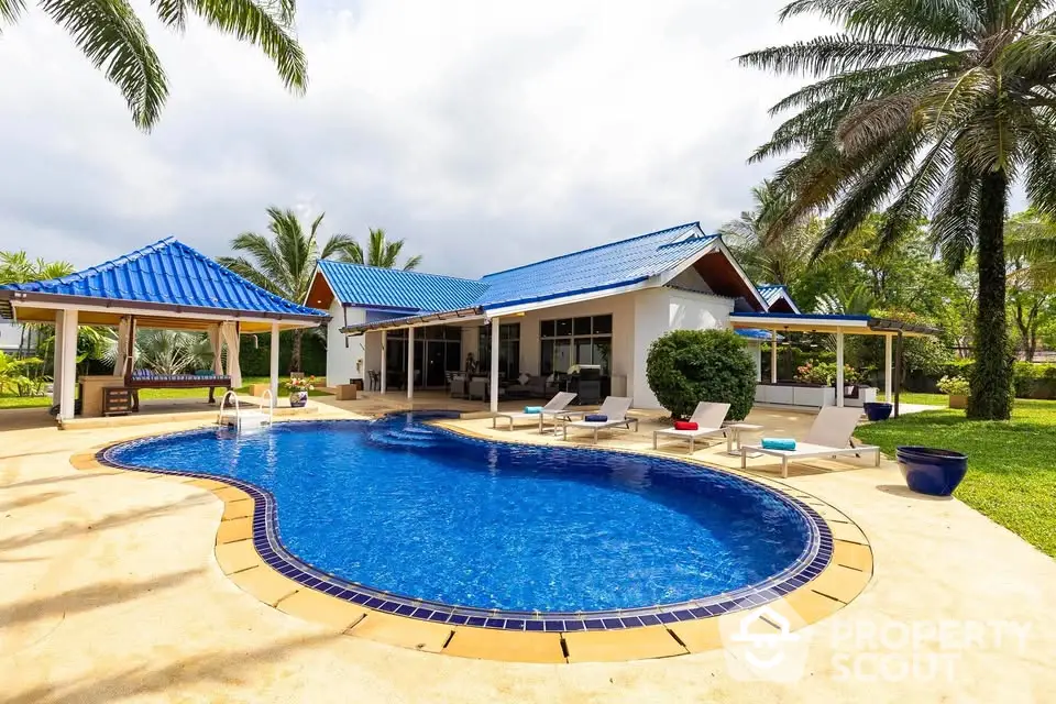 Luxurious villa with private pool and palm trees, perfect for tropical living.