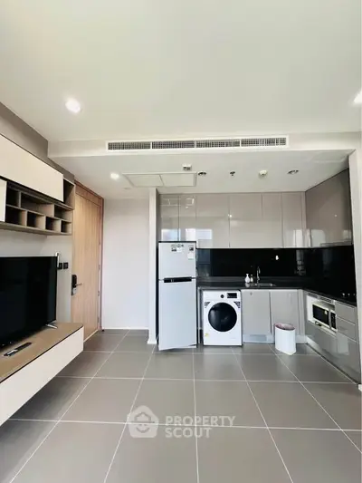 Modern kitchen with sleek cabinetry, appliances, and open layout in a stylish apartment.