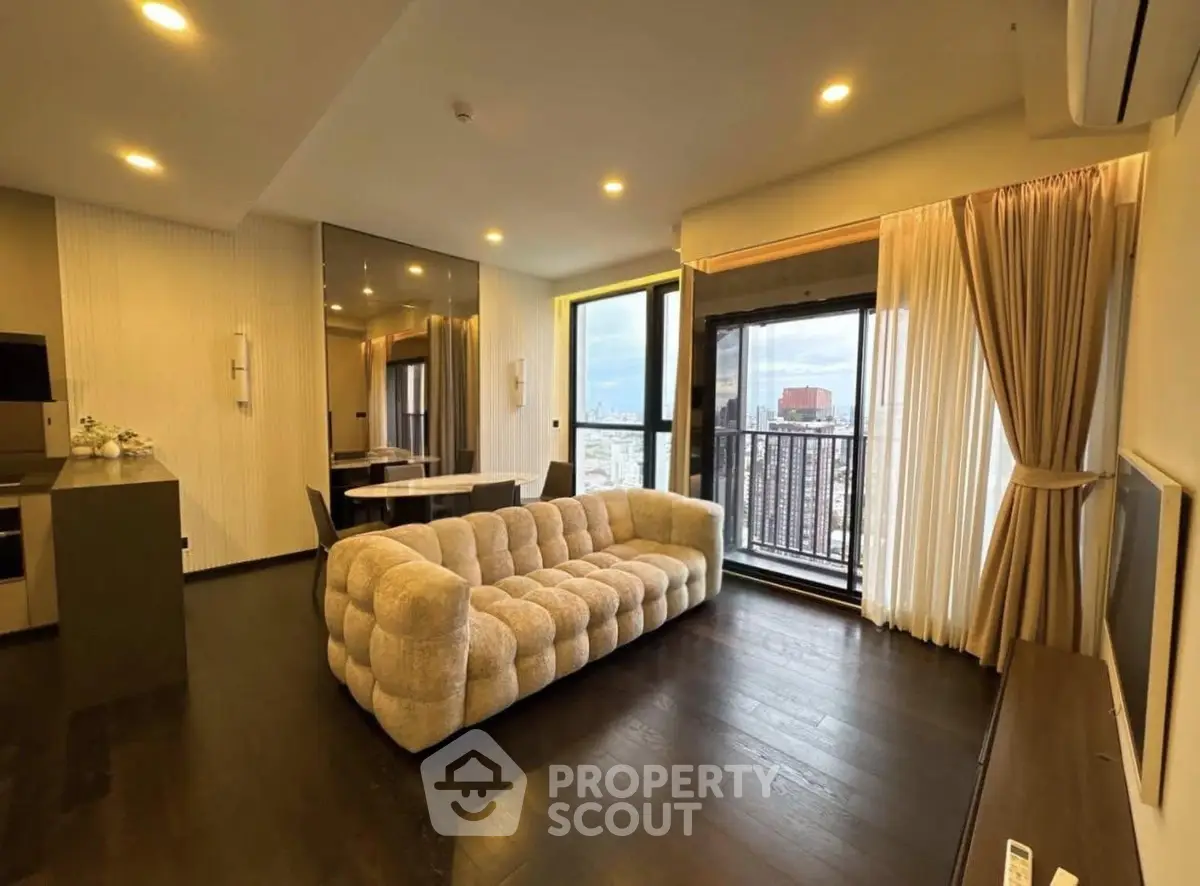 Luxurious living room with plush sofa and city view balcony in modern apartment