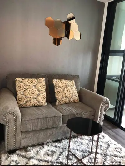 Cozy living room with plush sofa, decorative pillows, and modern wall art, perfect for relaxation.