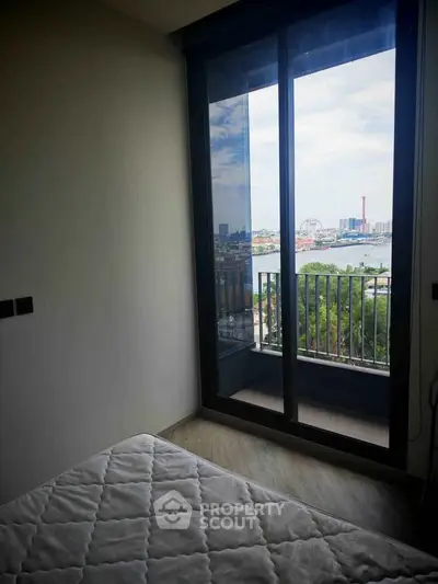 Cozy bedroom with balcony offering stunning city view
