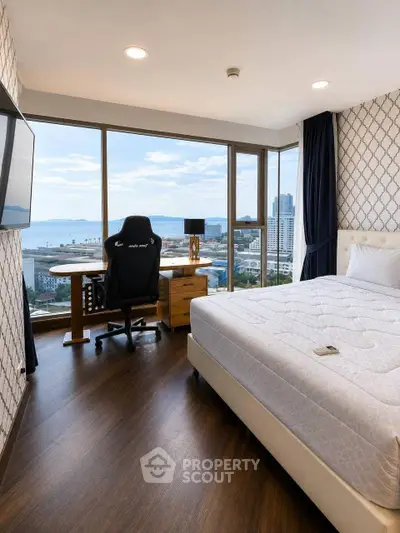 Luxurious bedroom with stunning ocean view and modern decor in high-rise apartment.