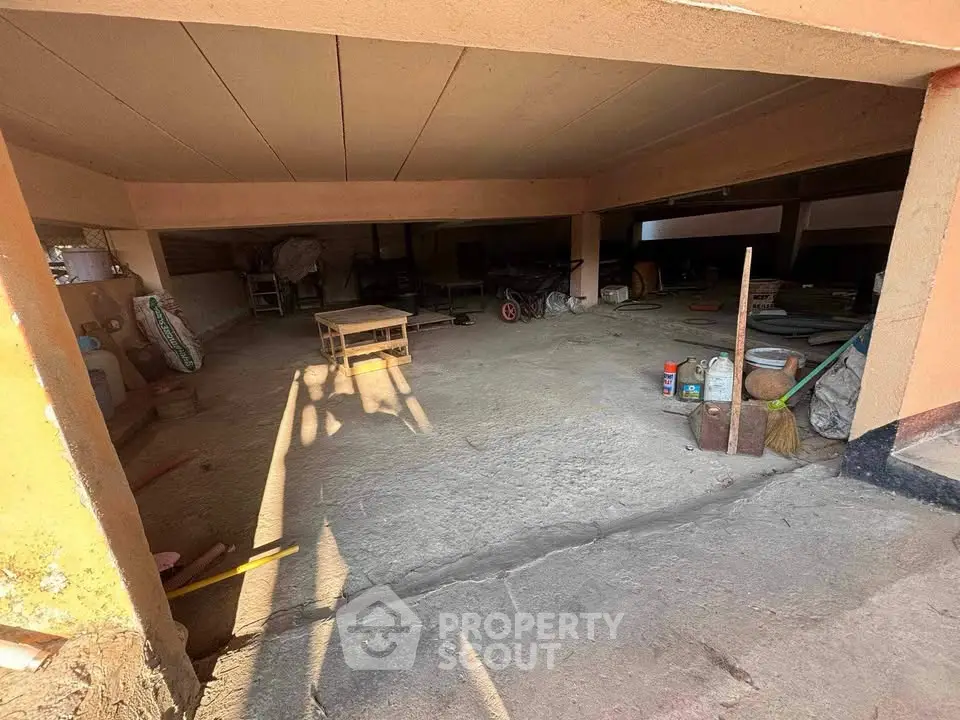 Spacious parking area with ample storage potential in residential building.