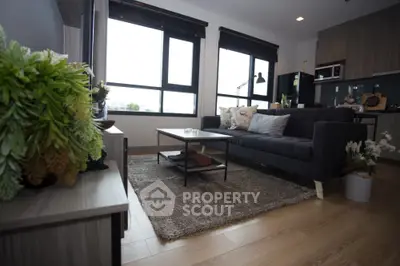 Modern living room with stylish decor and open kitchen layout