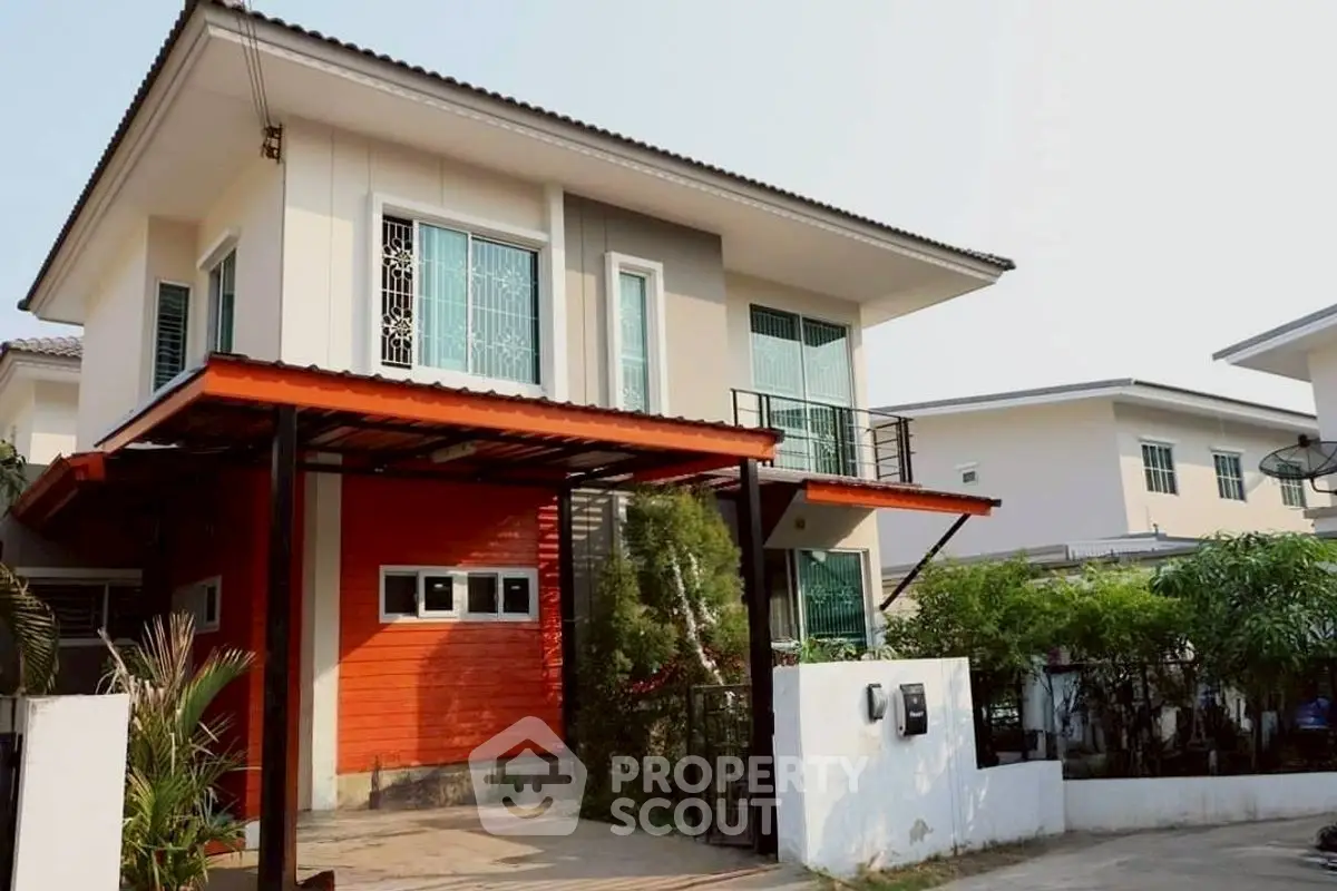Modern two-story house with stylish facade and carport in a serene neighborhood.