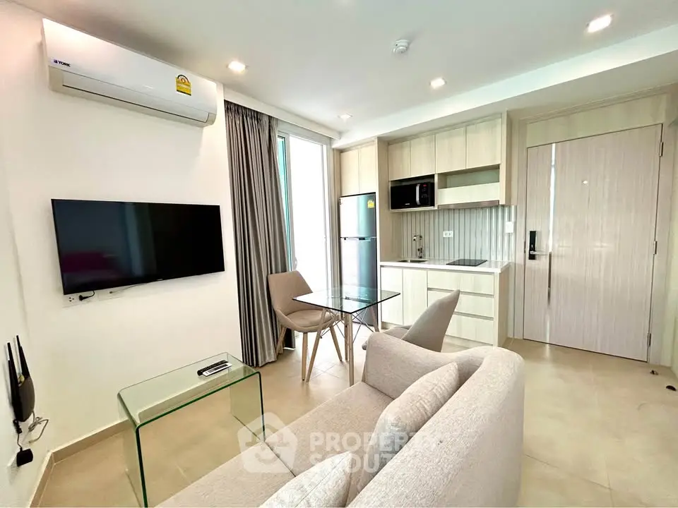 Modern living room with sleek furniture and integrated kitchen in a stylish apartment.