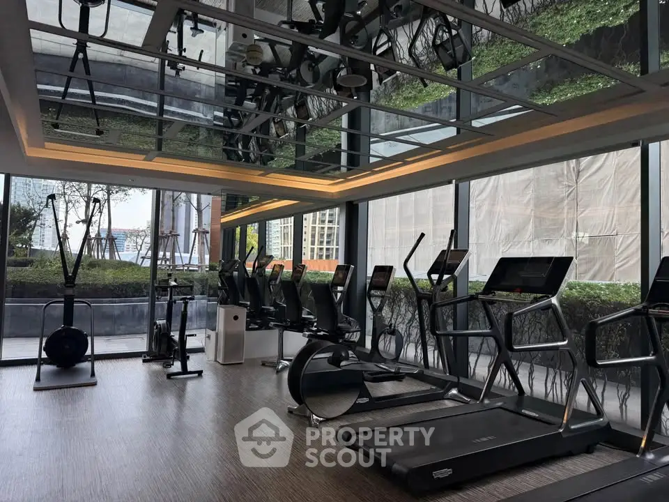 Modern gym with state-of-the-art equipment and large windows offering scenic views.