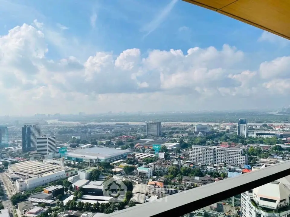 Stunning cityscape view from a high-rise balcony with expansive skyline and clear blue skies.