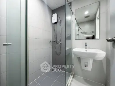 Modern bathroom with glass shower enclosure and sleek fixtures
