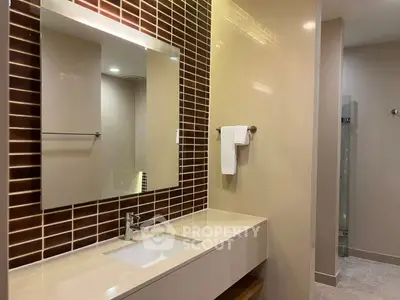 Modern bathroom with sleek vanity and stylish tile backsplash
