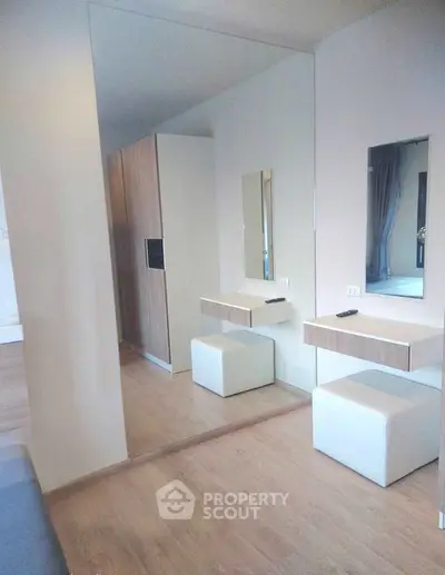 Modern bedroom with stylish wooden wardrobe and mirrored vanity area