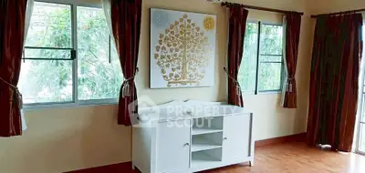 Bright room with elegant wall art and large windows, perfect for a cozy living space.