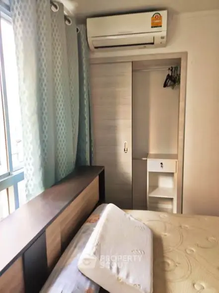 Cozy bedroom with air conditioning and built-in wardrobe, perfect for comfortable living.