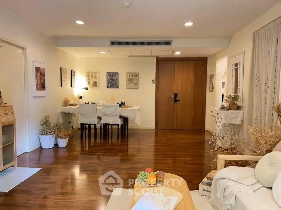 Spacious living room with elegant dining area and wooden flooring