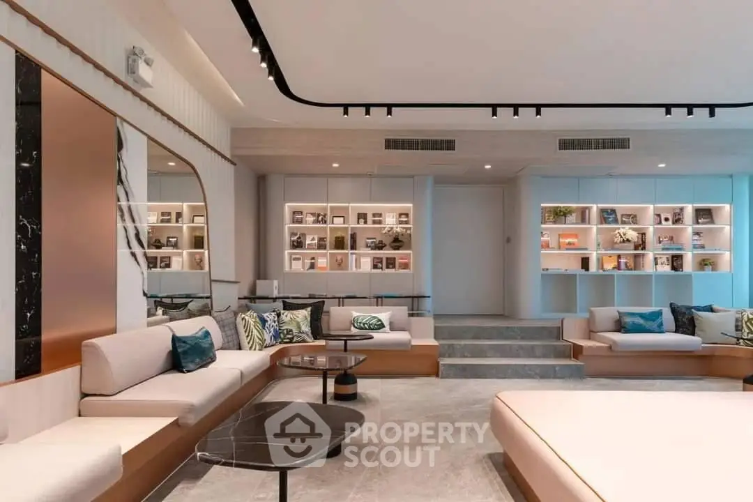 Luxurious modern living room with elegant decor and built-in bookshelves, perfect for relaxation and entertainment.