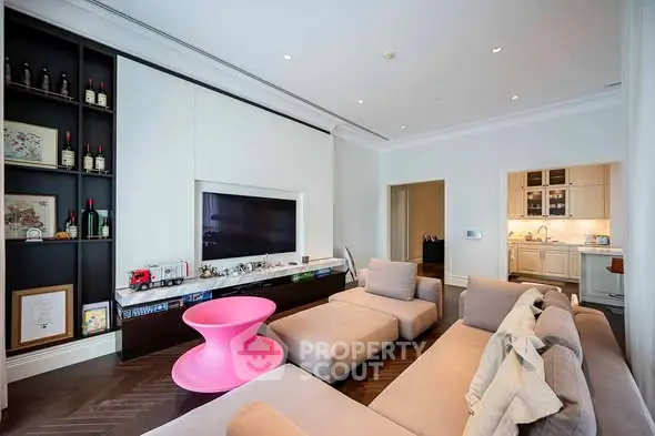 Modern living room with unique pink table and cozy sectional sofa