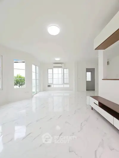 Spacious and bright living room with marble flooring and modern design.