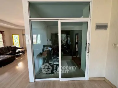 Spacious living area with glass sliding doors and modern decor
