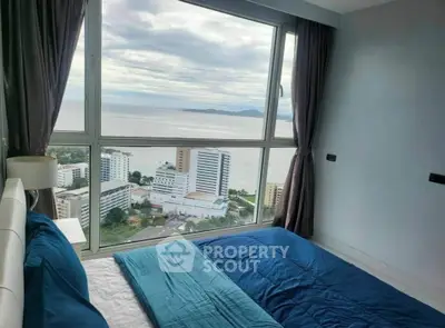 Stunning bedroom with panoramic ocean view in high-rise apartment