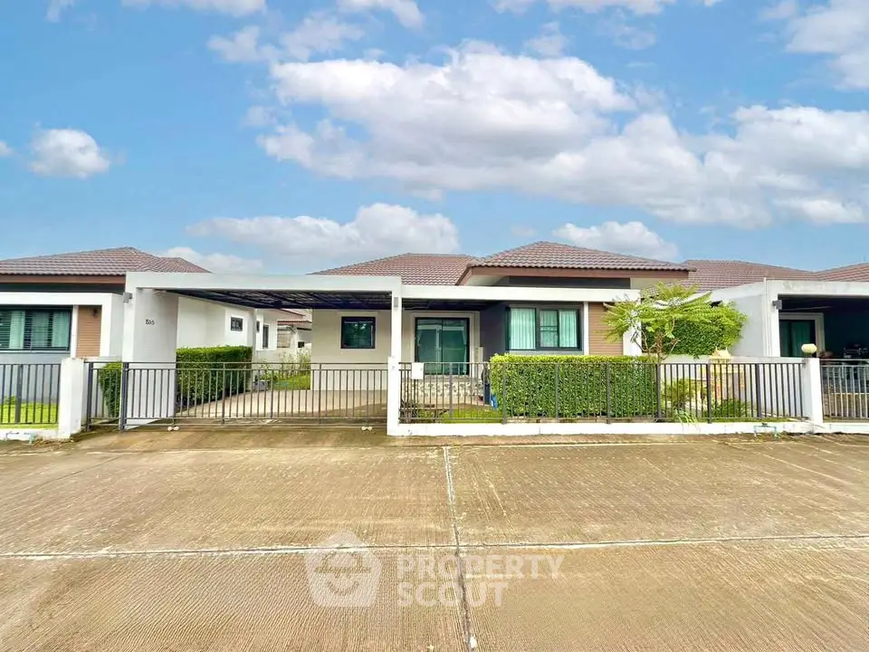 Charming single-story house with modern design and spacious driveway in a serene neighborhood.