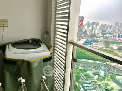 High-rise balcony with city view and washing machine setup, ideal for urban living.
