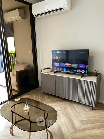 Modern living room with sleek TV setup and balcony view