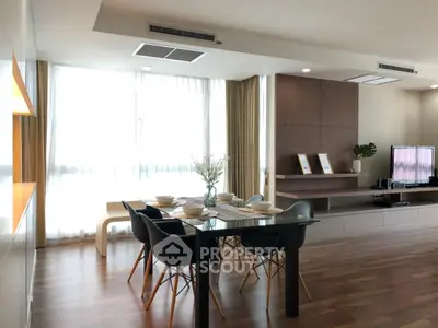 Modern dining area with elegant table and chairs, featuring stylish decor and natural light.