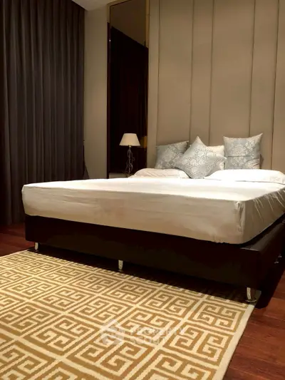Luxurious bedroom with elegant decor and plush bedding in modern apartment.