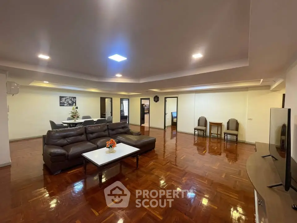 Spacious living room with elegant wooden flooring and modern furniture
