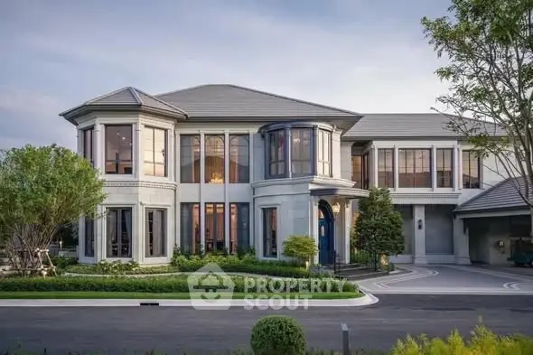 Luxurious modern mansion with elegant architecture and lush landscaping