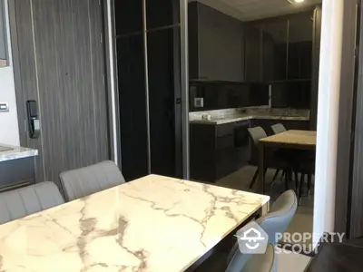 Modern kitchen with marble dining table and sleek cabinetry