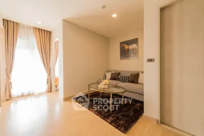 Cozy living room with elegant decor and natural light, featuring a plush sofa and stylish coffee table.
