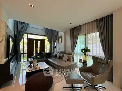 Luxurious modern living room with elegant decor and large windows