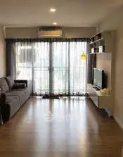 Modern living room with large window and stylish furniture