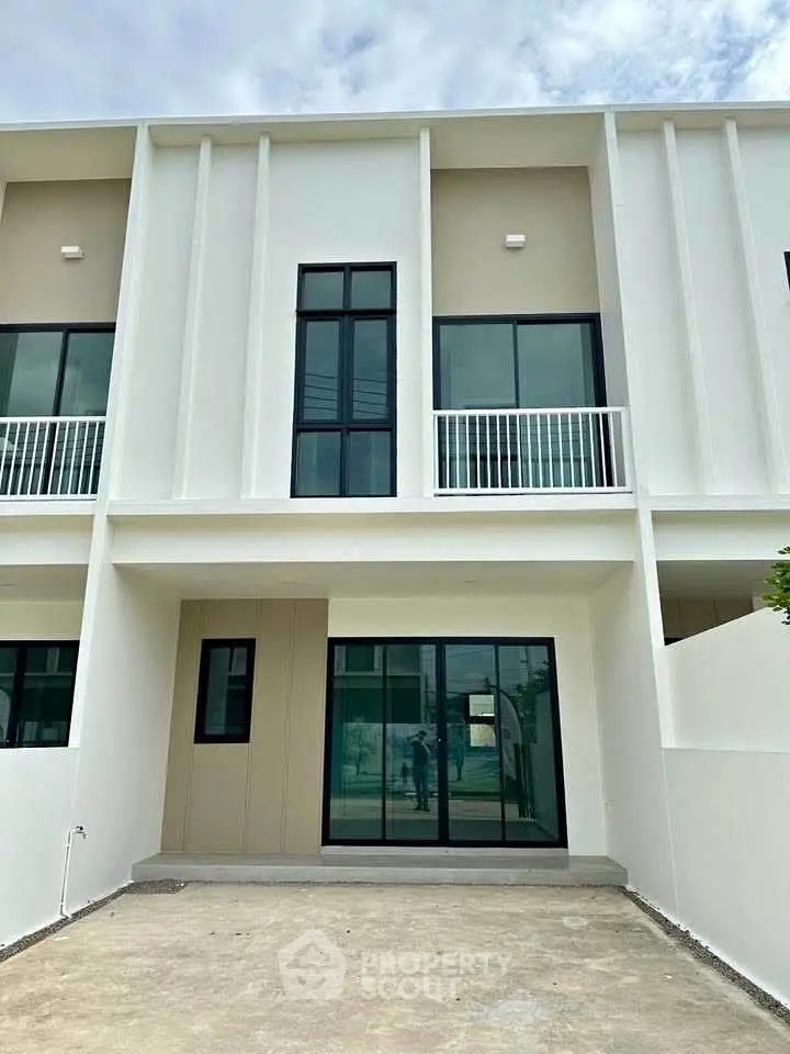 Modern townhouse exterior with sleek design and large windows