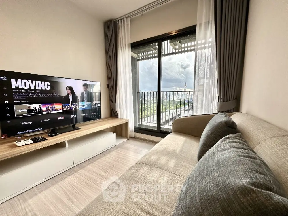 Modern living room with large TV and balcony view in stylish apartment