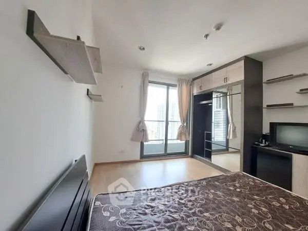Spacious bedroom with balcony access and modern decor