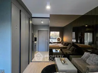 Modern living room with sleek design and cozy seating area in a stylish apartment.