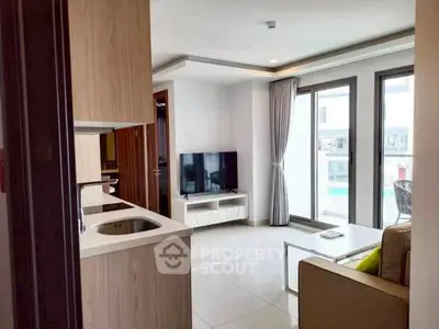 Modern living room with sleek design and pool view, featuring a cozy seating area and large windows.